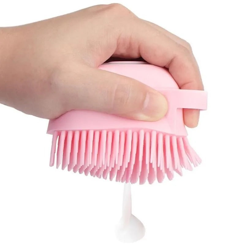 Brosse de douche doseuse rose pressée pour faire sortir le gel douche à travers les picots en silicone